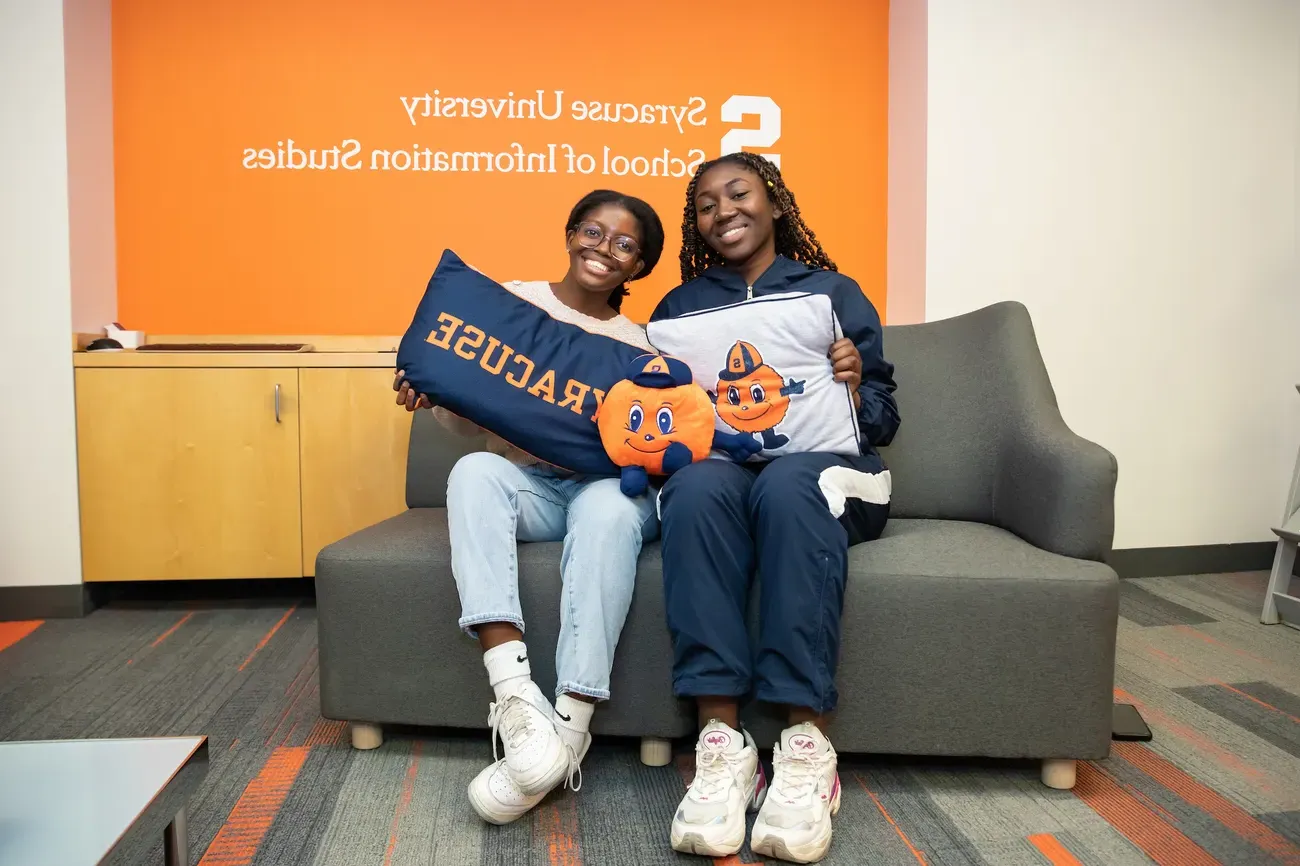 Two people sitting on a couch.